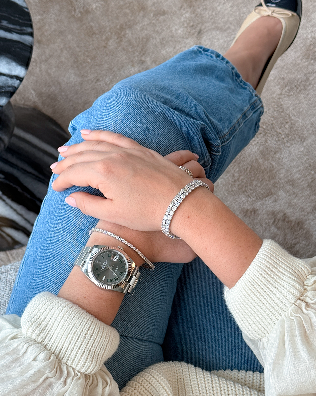 Diamond bracelets and a watch styled with a relaxed ivory and denim look